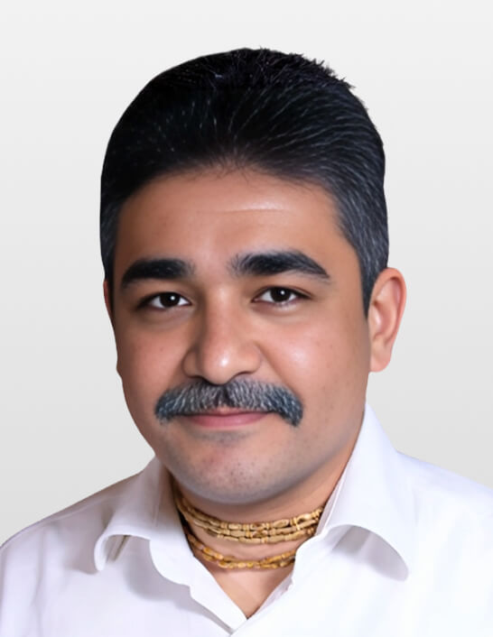 Person wearing traditional attire and necklace.