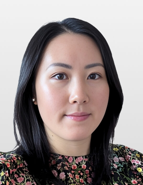 Person with long dark hair, floral top.